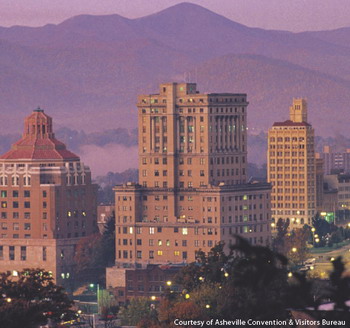 A photo of the cityscape of Asheville, North Carolina with the mountains as a background